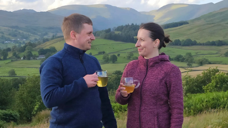 Diana and David enjoying Wander Cuppa loose leaf tea on a mountaintop. Beautiful scenery, perfect for relaxation.