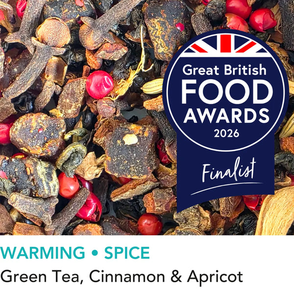 Bothy Hearth spiced green loose leaf tea with cinnamon ginger and pink pepper from Wander Cuppa. This premium tea is a warming green tea infusion inspired by Scottish fireside moments, perfect for a comforting cuppa tea or afternoon tea in Scotland. As a wholesale tea supplier UK, we provide this vegan tea and full leaf tea for cafes and retail across the UK. High-quality loose leaf tea near me featuring green tea leaves blended with aromatic spices and apricot pieces.