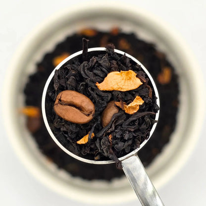 Edinburgh Dusk black loose leaf tea with roasted coffee beans and rose petals from Wander Cuppa. This premium tea is an energising Scottish blend inspired by the capital, perfect for a relaxing cuppa tea or afternoon tea. As a wholesale tea supplier UK, we provide this vegan tea and full leaf tea for cafes and retail across Scotland and the UK. A unique blend of loose leaf tea near me featuring bold black tea leaves, cocoa, and coffee beans.