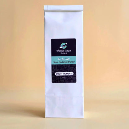 Forth Tide lemon and ginger green loose leaf tea from Wander Cuppa. This premium tea is an energising Scottish blend with lemongrass and lemon peels inspired by coastal air. As a wholesale tea supplier UK, we provide this refreshing vegan tea and full leaf tea for cafes and retail across Scotland and the UK. High-quality green tea with ginger and lemon wedges for a perfect cuppa tea.