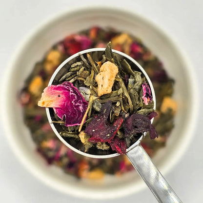 Kinross Fields green loose leaf tea from Wander Cuppa featuring a refreshing floral blend of lavender, hibiscus, rose petals, and elderflower with apple pieces. This premium tea is a caffeinated Scottish favourite inspired by the fields of Kinross, ideal for a morning cuppa tea or a relaxing afternoon tea. As a leading wholesale tea supplier UK, we offer this vegan tea and full leaf tea for retail and hospitality across Scotland and the UK. High-quality loose leaf tea near me providing a calming escape and 